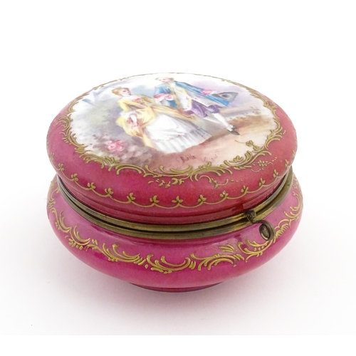 60 - A Sevres porcelain jewellery / trinket box of circular form, the lid decorated with hand painted cou... 