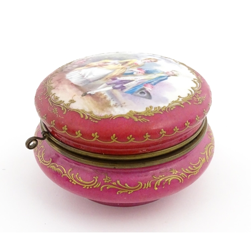 60 - A Sevres porcelain jewellery / trinket box of circular form, the lid decorated with hand painted cou... 