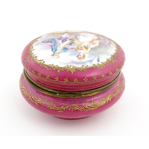 60 - A Sevres porcelain jewellery / trinket box of circular form, the lid decorated with hand painted cou... 