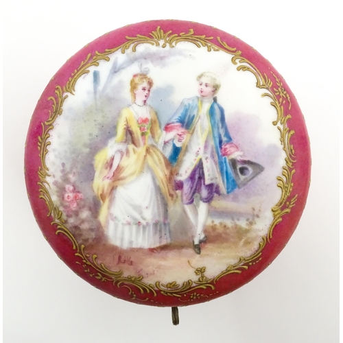 60 - A Sevres porcelain jewellery / trinket box of circular form, the lid decorated with hand painted cou... 