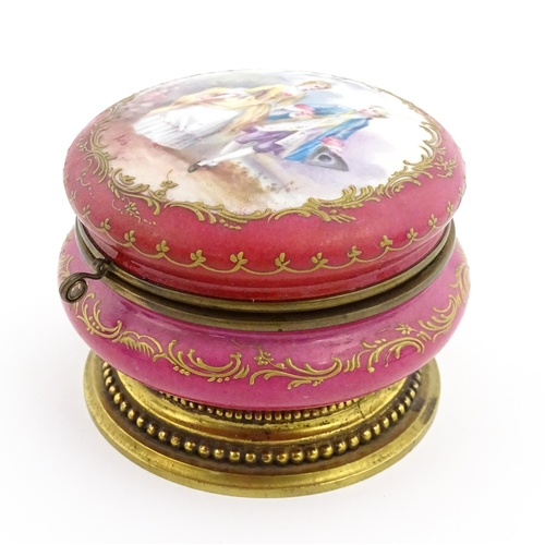 60 - A Sevres porcelain jewellery / trinket box of circular form, the lid decorated with hand painted cou... 