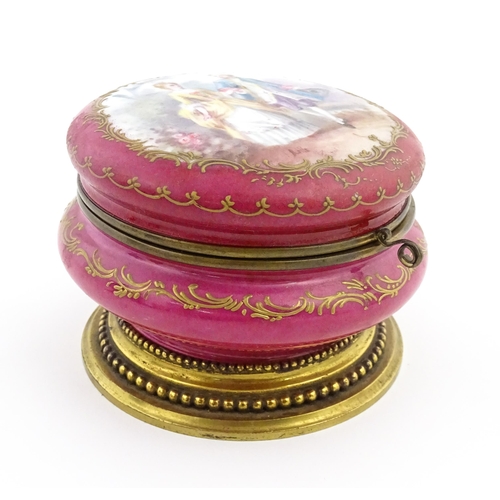 60 - A Sevres porcelain jewellery / trinket box of circular form, the lid decorated with hand painted cou... 