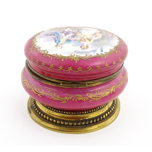 60 - A Sevres porcelain jewellery / trinket box of circular form, the lid decorated with hand painted cou... 