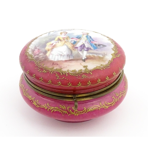 60 - A Sevres porcelain jewellery / trinket box of circular form, the lid decorated with hand painted cou... 