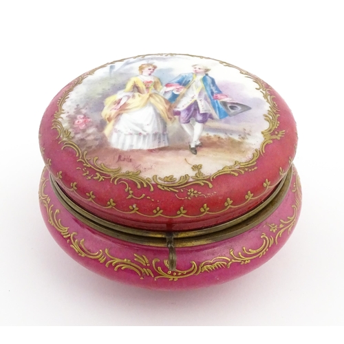 60 - A Sevres porcelain jewellery / trinket box of circular form, the lid decorated with hand painted cou... 