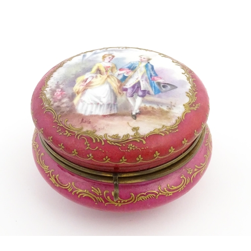 60 - A Sevres porcelain jewellery / trinket box of circular form, the lid decorated with hand painted cou... 