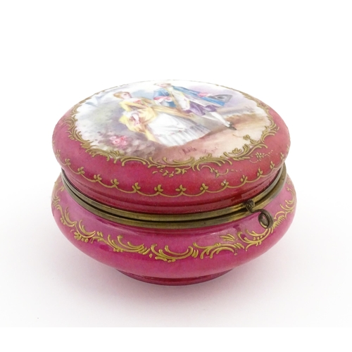 60 - A Sevres porcelain jewellery / trinket box of circular form, the lid decorated with hand painted cou... 