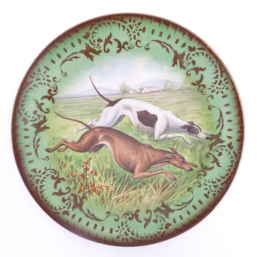 67 - A French St Amand Lebacqz & Bouchard plate decorated with hunting dogs after R. K. Beck. Approx. 11 ... 