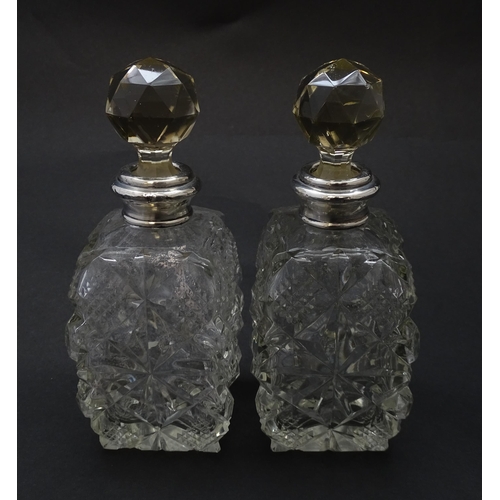 178 - Two cut glass scent bottles with silver collars, hallmarked London 1921. Approx 6 1/