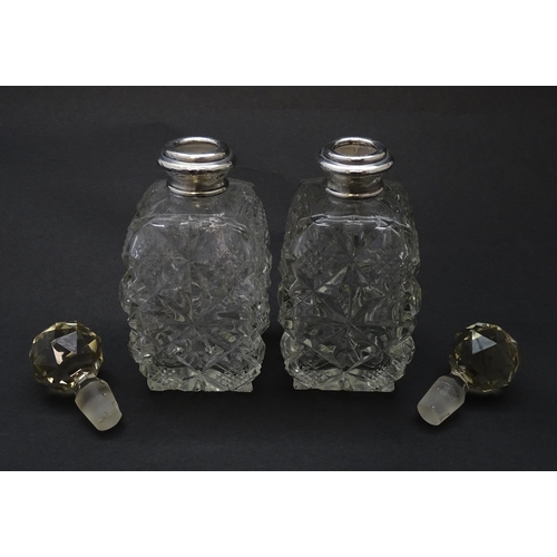 178 - Two cut glass scent bottles with silver collars, hallmarked London 1921. Approx 6 1/