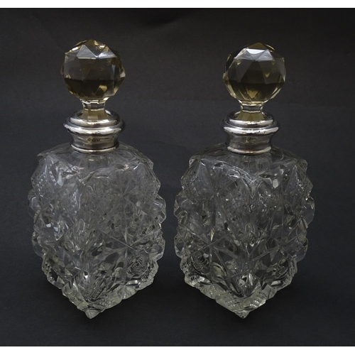 178 - Two cut glass scent bottles with silver collars, hallmarked London 1921. Approx 6 1/