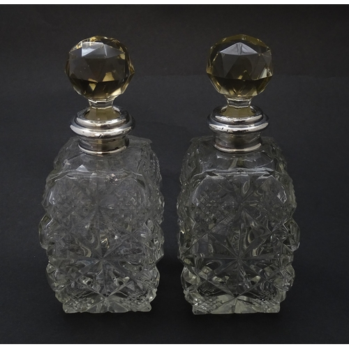 178 - Two cut glass scent bottles with silver collars, hallmarked London 1921. Approx 6 1/