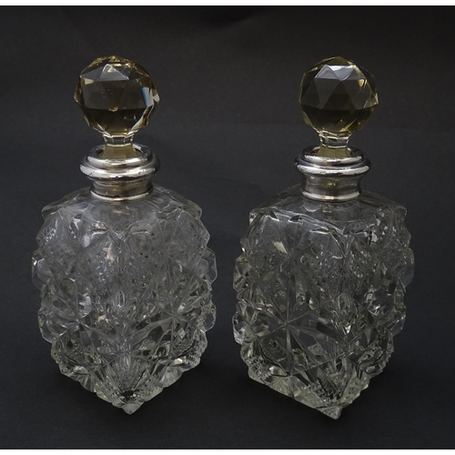 178 - Two cut glass scent bottles with silver collars, hallmarked London 1921. Approx 6 1/