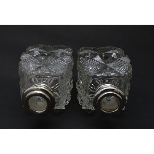 178 - Two cut glass scent bottles with silver collars, hallmarked London 1921. Approx 6 1/