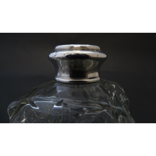 178 - Two cut glass scent bottles with silver collars, hallmarked London 1921. Approx 6 1/