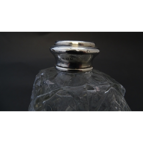 178 - Two cut glass scent bottles with silver collars, hallmarked London 1921. Approx 6 1/