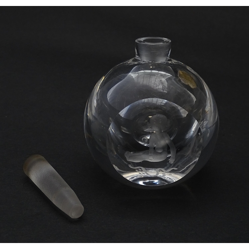 179 - An Orrefors scent bottle / perfume flask with figural decoration. Approx. 4 1/4