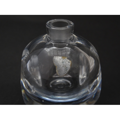 179 - An Orrefors scent bottle / perfume flask with figural decoration. Approx. 4 1/4