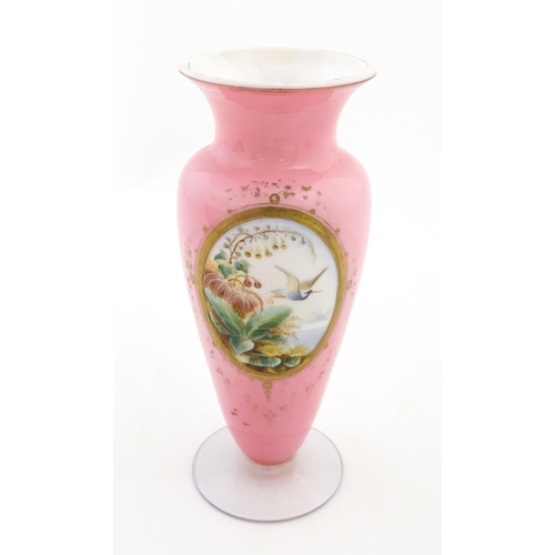 184 - A 19thC pink opaline glass vase with hand painted oval depicting floral and foliate scene with crane... 