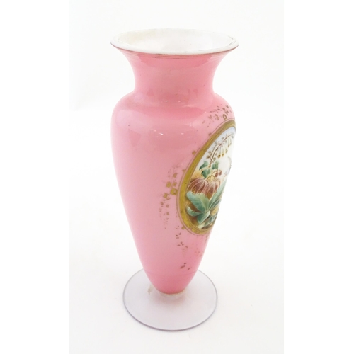 184 - A 19thC pink opaline glass vase with hand painted oval depicting floral and foliate scene with crane... 