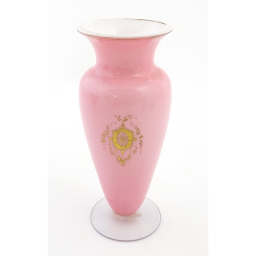 184 - A 19thC pink opaline glass vase with hand painted oval depicting floral and foliate scene with crane... 