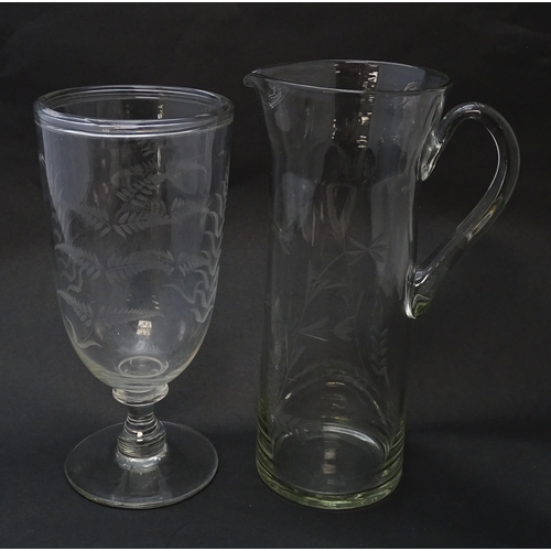 188 - A pedestal glass celery vase with engraved fern decoration together with a glass jug with loop handl... 