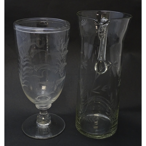 188 - A pedestal glass celery vase with engraved fern decoration together with a glass jug with loop handl... 