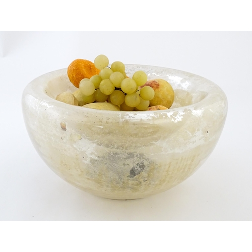 193 - A late 20thC Mercury glass style bowl together with a quantity of painted faux alabaster fruit. The ... 