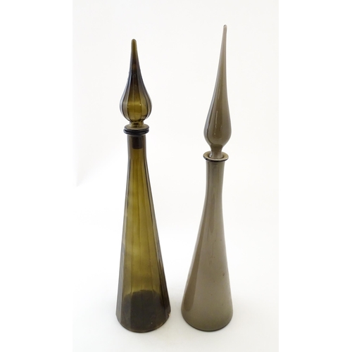 233 - Two tall Empoli style glass decanters of elongated tapering form. Largest approx. 25 3/4