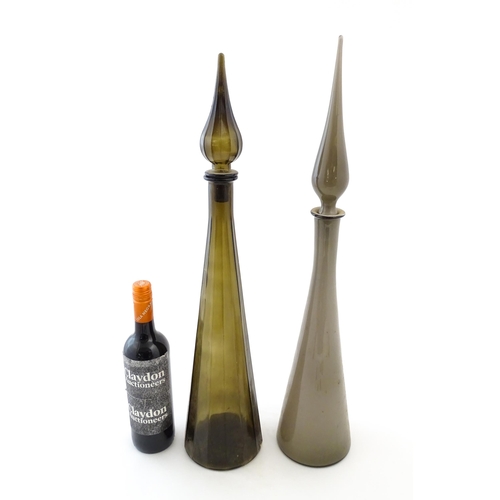 233 - Two tall Empoli style glass decanters of elongated tapering form. Largest approx. 25 3/4