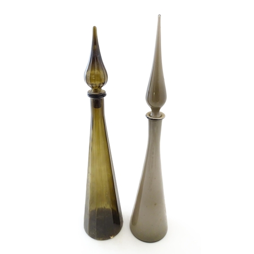 233 - Two tall Empoli style glass decanters of elongated tapering form. Largest approx. 25 3/4