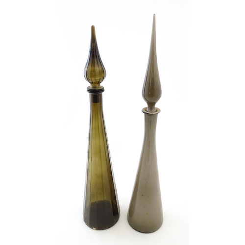 233 - Two tall Empoli style glass decanters of elongated tapering form. Largest approx. 25 3/4