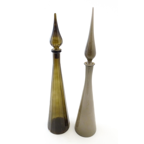 233 - Two tall Empoli style glass decanters of elongated tapering form. Largest approx. 25 3/4