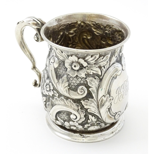 260 - A silver christening mug with floral and acanthus decoration. Hallmarked Birmingham 1908 maker The A... 