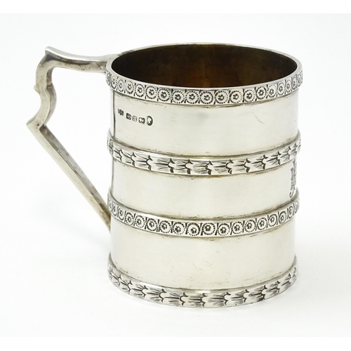 296 - A Victorian silver christening mug of tankard form with banded decoration and gilded interior.  hall... 