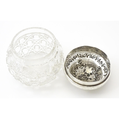 328 - A cut glass dressing table jar with embossed silver lid hallmarked London 1902, maker William Comyns... 