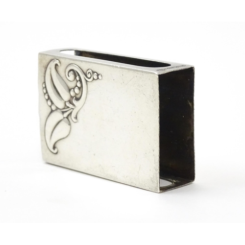 393 - A silver match box cover with floral detail, marked Sterling. Approx. 1 3/4