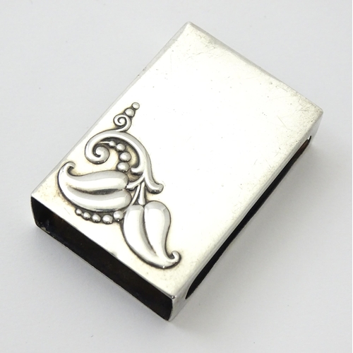 393 - A silver match box cover with floral detail, marked Sterling. Approx. 1 3/4