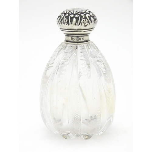 398 - A glass scent / perfume bottle with silver lid hallmarked Chester 1905, maker James Deakin & Sons. A... 