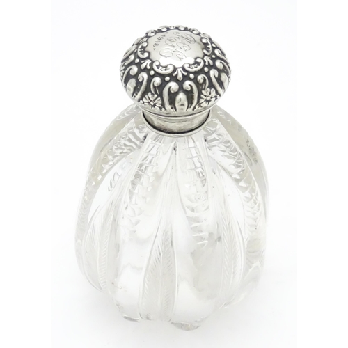 398 - A glass scent / perfume bottle with silver lid hallmarked Chester 1905, maker James Deakin & Sons. A... 