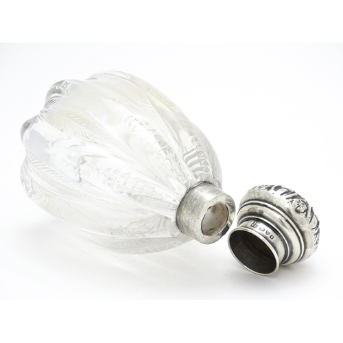 398 - A glass scent / perfume bottle with silver lid hallmarked Chester 1905, maker James Deakin & Sons. A... 