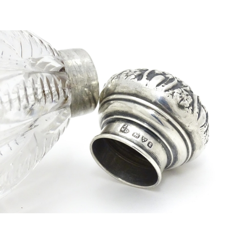 398 - A glass scent / perfume bottle with silver lid hallmarked Chester 1905, maker James Deakin & Sons. A... 