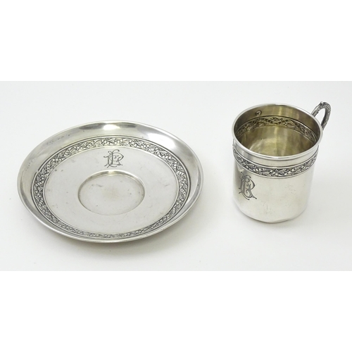 406 - A French silver cup and saucer with banded decoration, maker Gustave Veyrat. Cup approx. 2 1/2