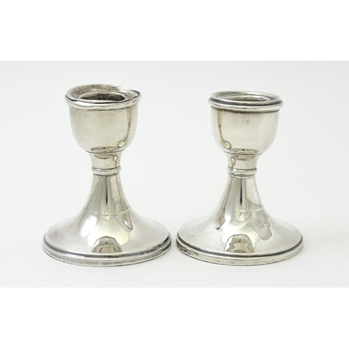 414 - A pair of silver candlesticks of squat form hallmarked Birmingham 1946. Approx. 3