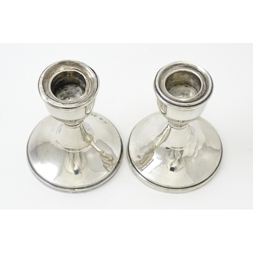 414 - A pair of silver candlesticks of squat form hallmarked Birmingham 1946. Approx. 3