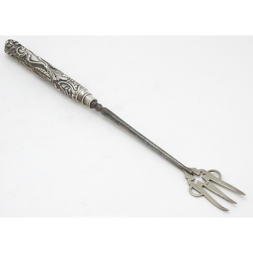 418 - A Victorian silver handled bread fork with embossed decoration, hallmarked Birmingham 1892, maker Ad... 