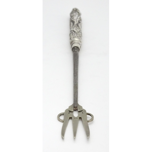 418 - A Victorian silver handled bread fork with embossed decoration, hallmarked Birmingham 1892, maker Ad... 