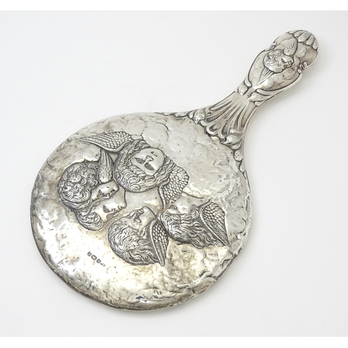 421 - A silver hand mirror with cherub decoration hallmarked Birmingham 1904, maker Mitchell Bosley & Co. ... 