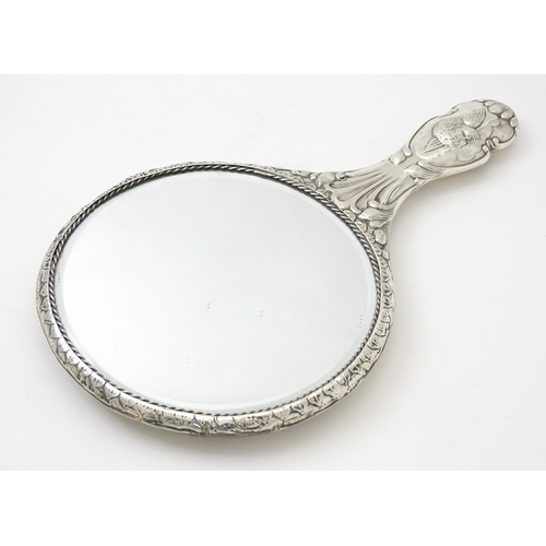 421 - A silver hand mirror with cherub decoration hallmarked Birmingham 1904, maker Mitchell Bosley & Co. ... 