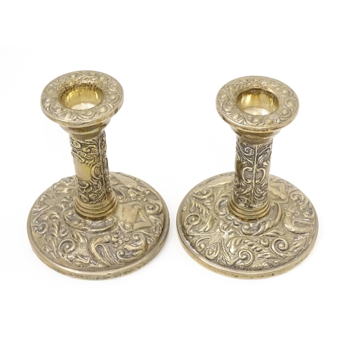 267 - A pair of silver candlesticks with floral scroll and bird decoration. Hallmarked Birmingham 1961, ma... 